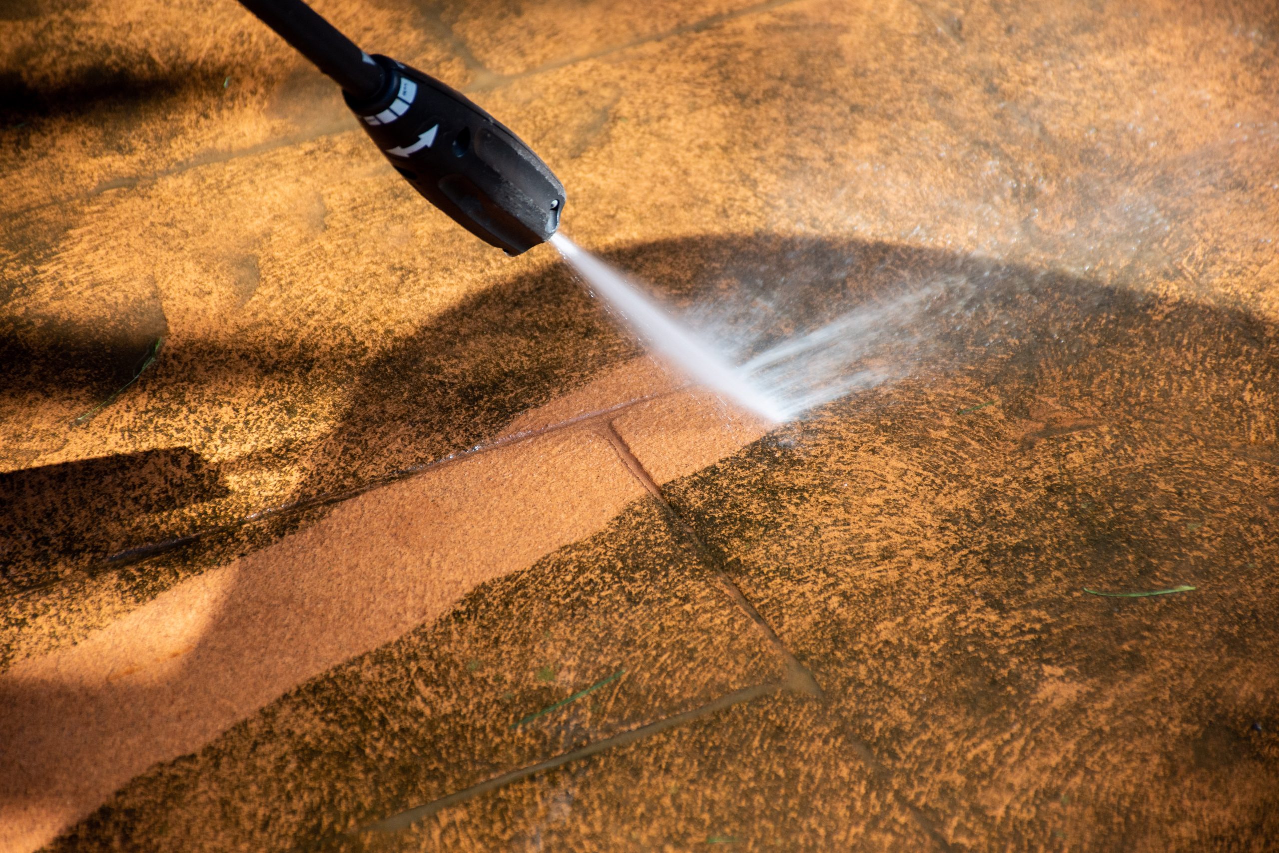 pressure-washing-an-outdoor-patio-tile-surface-2026-03-17-14-34-54-utc